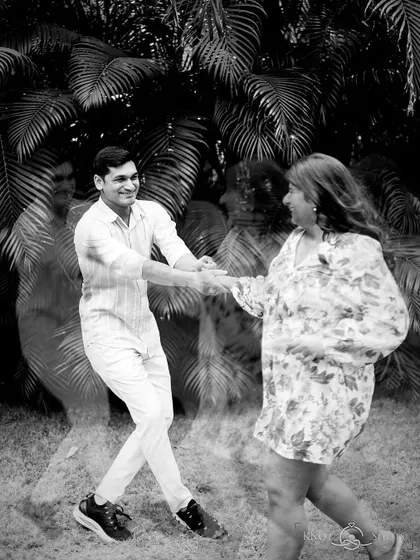 An artistic motion blur shot in black and white. This technique captures the energy and movement of the couple dancing, creating a dynamic and expressive portrait.
