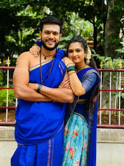 A client in a blue floral Langa Davani posing with a co-star. My outfits are also popular for on-screen appearances and television shows.