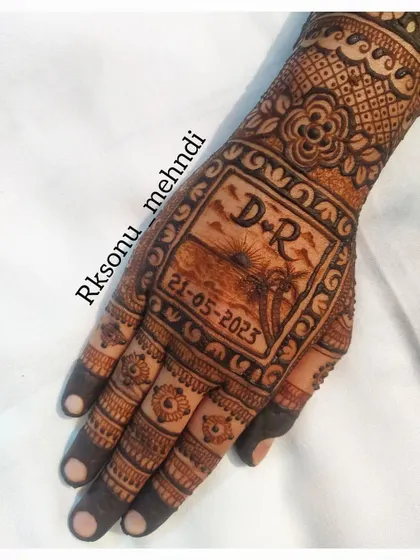 This design captures the memory of where the couple first met: a beautiful beach at sunset. Their initials "D+R" and the special date are immortalized in this scenic and romantic henna artwork.