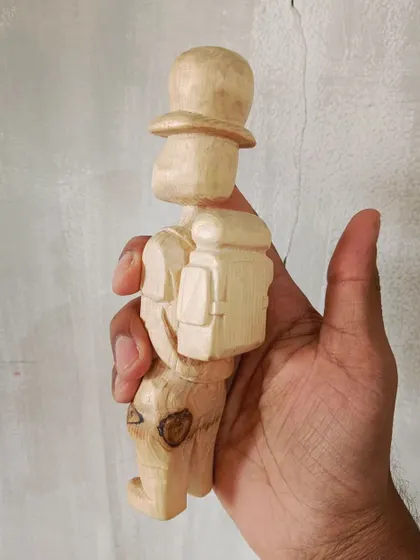 A duplicate of 128, this little traveler was carved from a chip of a tree found lying in the grass. We cleaned him up and gave him a new story.
