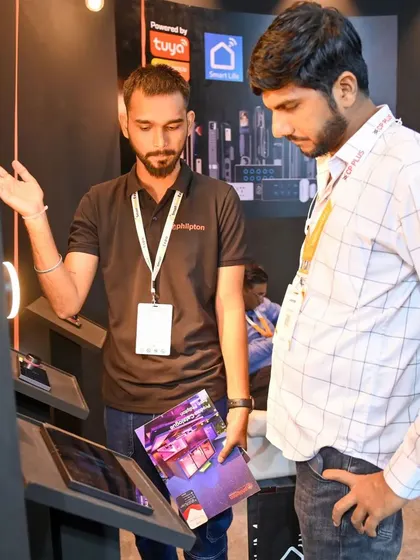 Discussing the future of home automation with a visitor at my booth. Events like these are crucial for sharing knowledge and showing how my central control panels can transform a home.