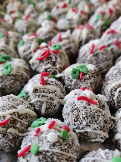 These Christmas rum balls are a bite-sized festive delight. They are made from our rich plum cake, rolled in coconut, and decorated with festive sprinkles.