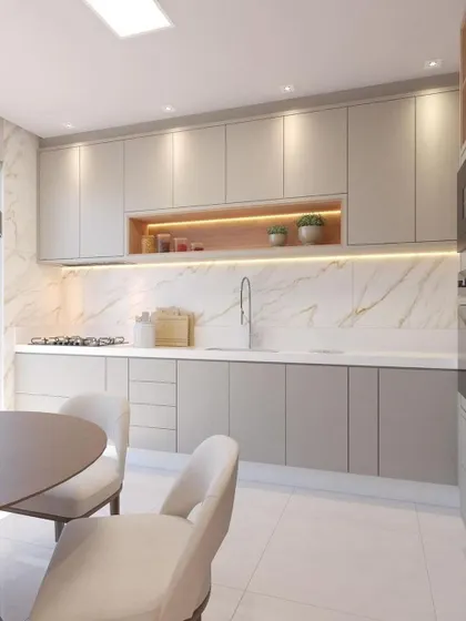 A minimalist kitchen design with light grey cabinets and a white marble-patterned backsplash. An open niche with wood-finish and backlighting serves as a stylish spot for displaying decor or everyday items.
