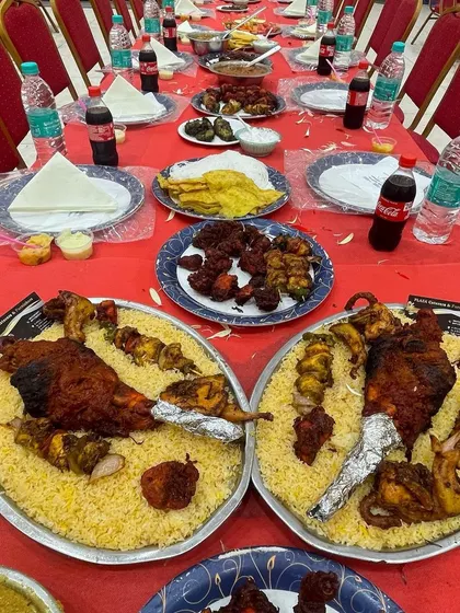 A stunning groom's table featuring two large platters of our special chicken Mandi biryani. This is a showstopper dish perfect for making a wedding feast unforgettable.