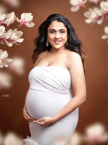 A stunning solo portrait of the mom-to-be. The classic white gown and the artistic floral frame create a timeless and elegant look that I just adore.