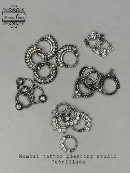 We stock a variety of septum jewelry, including these intricate clickers and rings. Notice the detailed metalwork and embedded crystals, designed to be both secure and eye-catching.