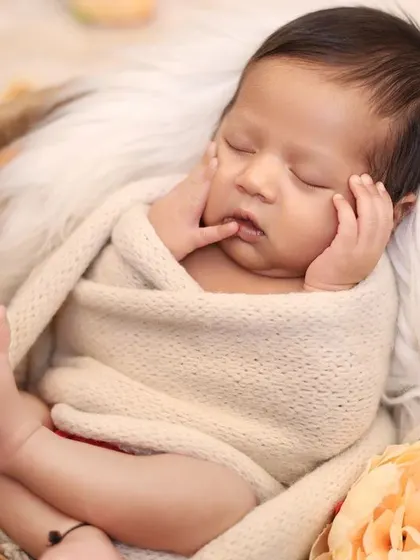 This pose is another angle from the same classic basket session, showing the baby's profile and tiny toes. Providing a variety of poses from a single setup gives you a complete story of the moment.
