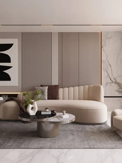 Soft sophistication defines this living room, where a curved sofa and armchairs create a gentle, welcoming flow. The minimalist artwork and subtle wall paneling add to the serene and elevated atmosphere.