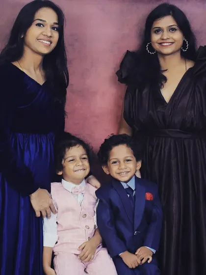 A family portrait featuring my brown satin gown and the royal blue velvet gown. It's wonderful to see my pieces as part of special family moments.
