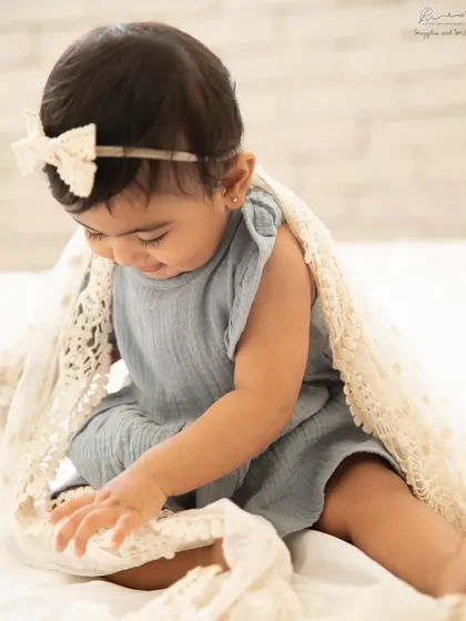Exploring textures and finding joy in the simplest things. This is the magic of the sitter stage, captured in a candid, happy moment.