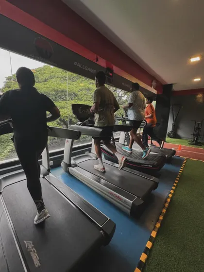A group of clients runs on the treadmills, creating a shared energy that makes cardio sessions more motivating.