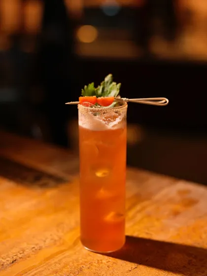 A full view of the refreshing Smoky Spritz, garnished with celery and tomato, highlighting its savoury and unique flavour profile.