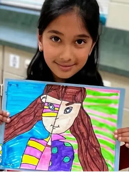 This student proudly presents her Picasso-inspired portrait. Our curriculum introduces children to different art styles and famous artists, broadening their creative horizons.