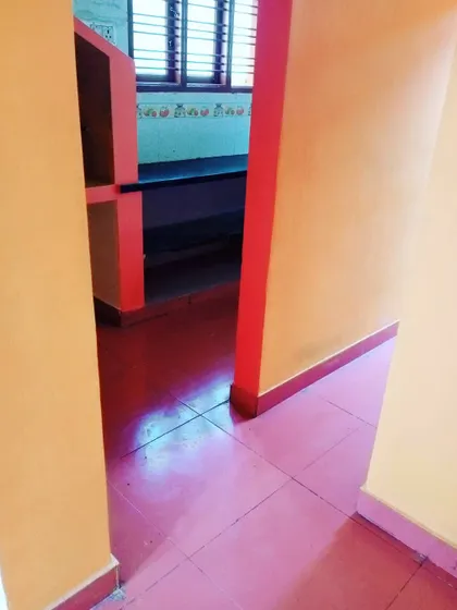 Another view of the kitchen entrance, showing the red trim and shelving against the lighter orange walls. We can handle multi-color interior designs.