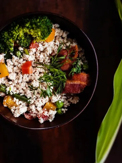 A close-up of my special keema meal, made with finely minced chicken, vibrant vegetables like bell peppers and peas, and topped with fresh dill. This is one of my most popular dishes, loved for its texture and flavor.