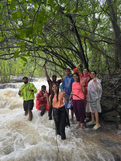 Carefully crossing a rushing stream with the help of a rope. Safety is always first, but a little adventure is what makes the trip memorable. This is a typical part of our waterfall treks in the monsoon.