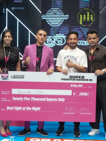 Kavinder Bisht receiving his prize for "Best Fight of the Night." It's not just about winning, but about putting on a performance that captivates the audience.