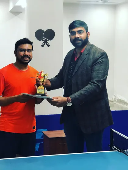 Celebrating a champion at our prize money tournament. We believe in rewarding skill and dedication, with trophies and cash prizes for top performers.