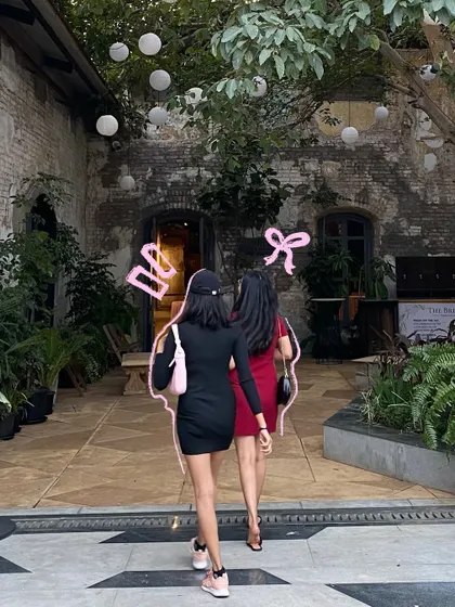 A "Gossip Girl" moment with my friend, highlighted with a pink outline and bow doodles.