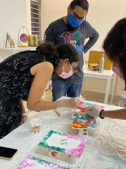 A snapshot from the private anniversary workshop, where the couple learned to work with alcohol inks to create personalized book covers and coasters.