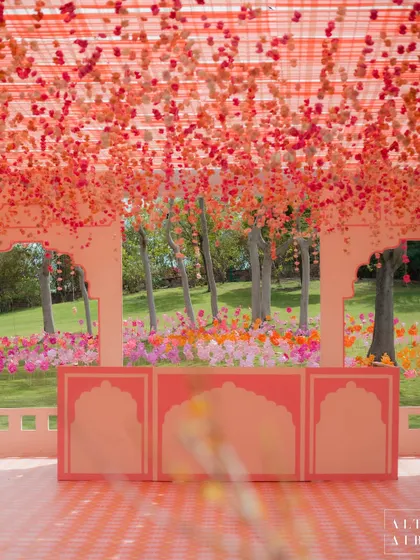 The stage at the 'Gulbahar' Holi party, featuring a ceiling of cascading pink flowers. The design was imagined as a quintessential Rajasthan courtyard, perfect for a fun-filled celebration.