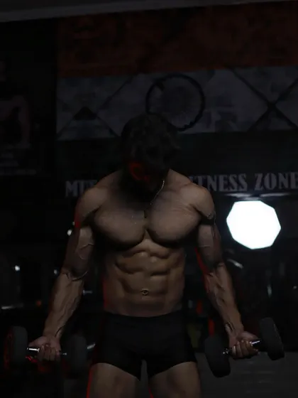 A close-up of my physique in the gym, showing the results of a disciplined workout plan. The focus here is on the chest and arm definition.