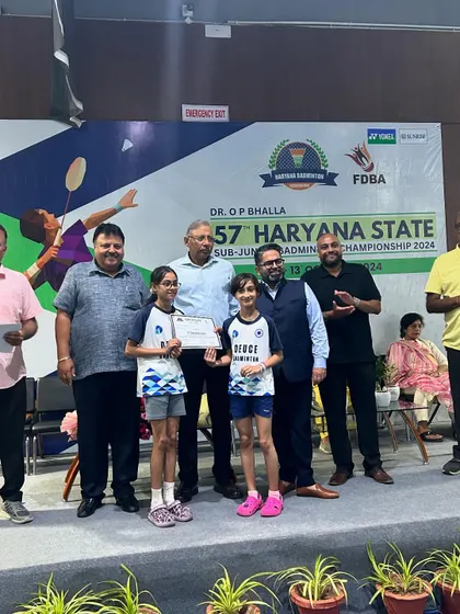 Arshiya and Samaira on the podium receiving their bronze medals for the U11 girls' doubles at the Haryana State Badminton Championship 2024.