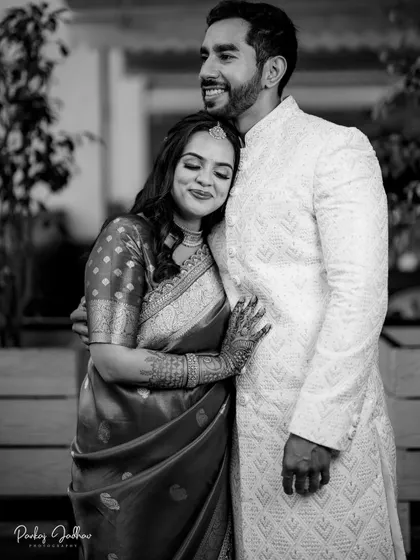 A black and white portrait of Ojasi finding a quiet moment of comfort with Rutvik during their engagement.