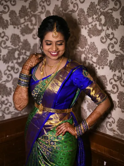 This pretty bride looks so happy and radiant for her engagement. Her traditional South Indian look features a beautiful silk saree and antique jewellery, enhanced by makeup that focuses on glowing skin and bright eyes.