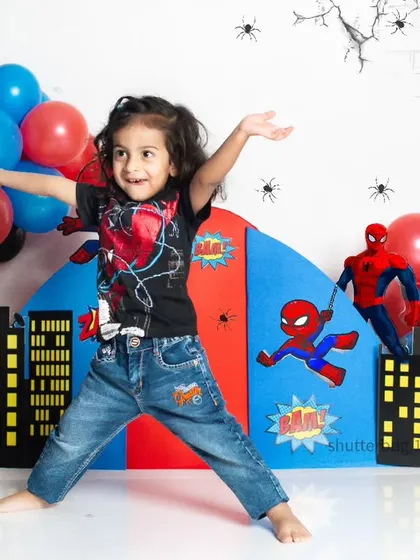 A dynamic action pose from a little Spiderman fan in front of our custom city skyline backdrop.