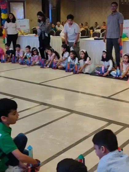 A wide shot of a rocket building session, showing how we organize the activity for a large group of children with adult supervision.