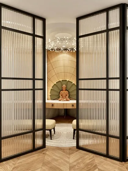 A tranquil meditation or prayer room concept, viewed through elegant fluted glass partitions. The design features a central Buddha statue, creating a serene and focused environment.