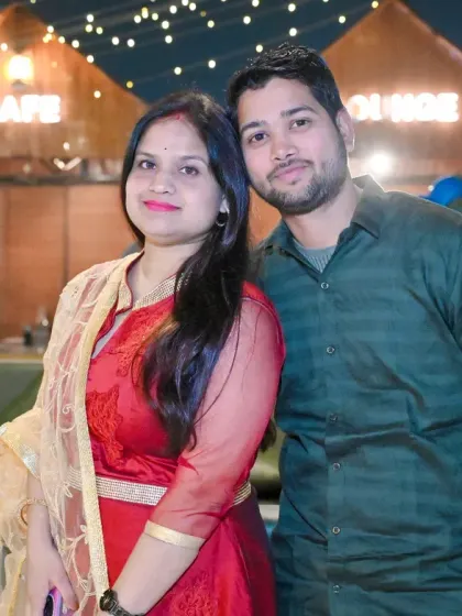 A sweet portrait of a couple at an outdoor cafe-style venue during a family gathering.