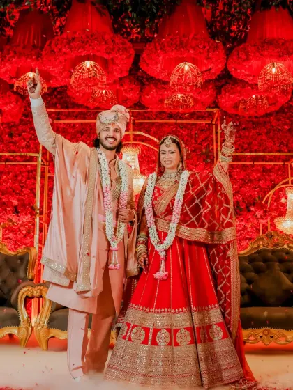 A celebratory shot of the couple on stage after their wedding ceremony.