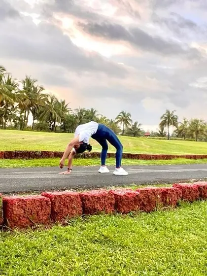 A full Urdhva Dhanurasana (Wheel Pose) on a path. Yoga does not just change the way we see things, it transforms the person who sees.