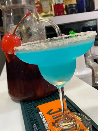 A striking Blue Lagoon cocktail, perfect for adding a pop of color to your event. This drink is a favorite for pool parties, sangeets, and vibrant celebrations.