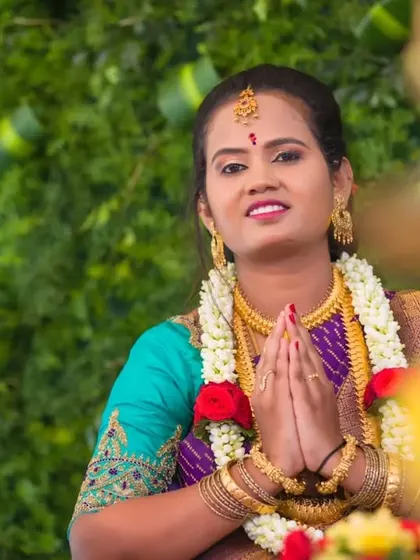 A moment of prayer during a traditional ceremony. Her makeup is respectfully elegant, with a flawless base and defined eyes, suitable for a sacred event.