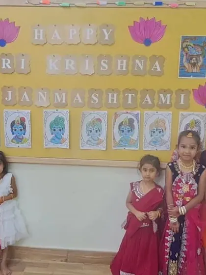 A group of our little Radhas in front of the Janmashtami decoration board. We ensure every child feels part of the celebration.