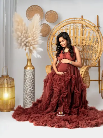 A solo portrait of the mom-to-be seated in the peacock chair.