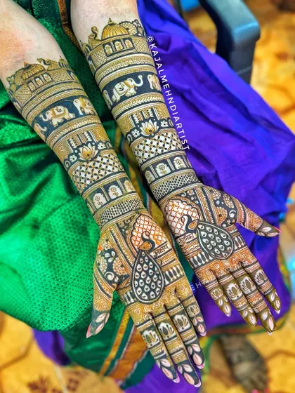 This bride's design combines majestic peacocks on the palms with royal elephants and palace architecture on the arms.