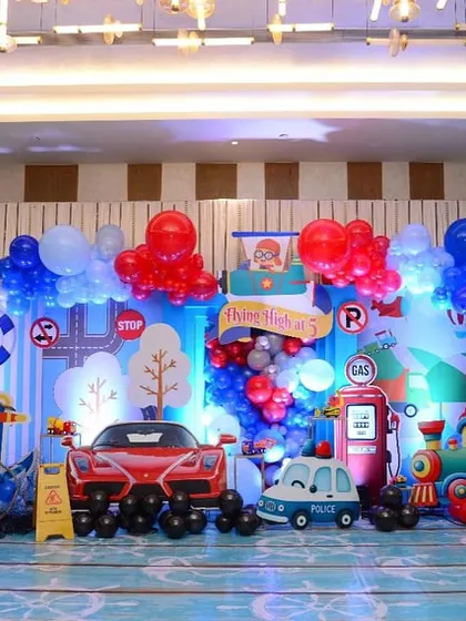 For Luv and Kussh's birthday, we created an elaborate travel-themed stage, featuring everything from cars and trains to ships and planes.