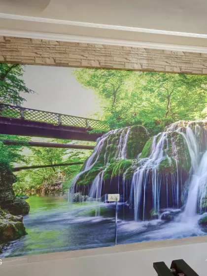 A hyper-realistic waterfall mural that brings the power and beauty of nature indoors. This kind of scenic wallpaper can make a room feel larger and more open.