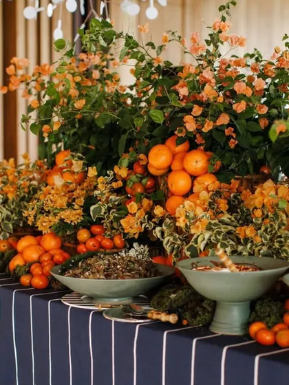 A bountiful and beautiful food display. I used fresh oranges and bougainvillea to decorate the buffet table, integrating the culinary experience with the overall citrus-themed decor of the garden party.