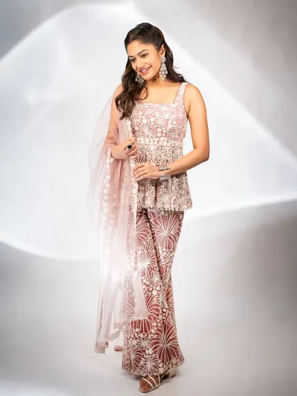 The full view of the blush pink sharara set shows its graceful flow and modern ethnic design. It's an ideal choice for a public figure needing an outfit that is both stylish and comfortable for events.
