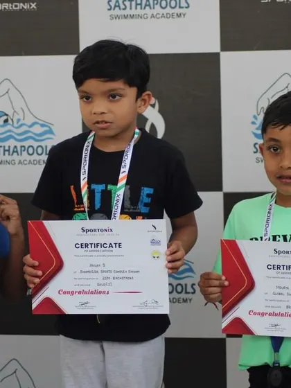 The youngest group of winners holding their certificates, the future of our swimming academy.