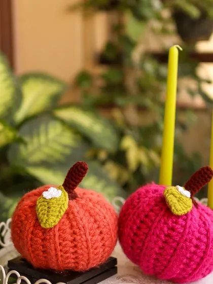 A pair of colourful pumpkins, in orange and pink, ready to brighten up a corner.