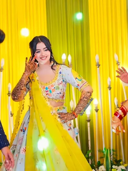 A happy bride showing off her henna while dancing with friends and family. Our mehndi is made to be a part of your celebration's energy and fun.