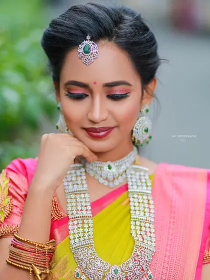 A close-up on the model's face, showing the maang tikka and choker detail.