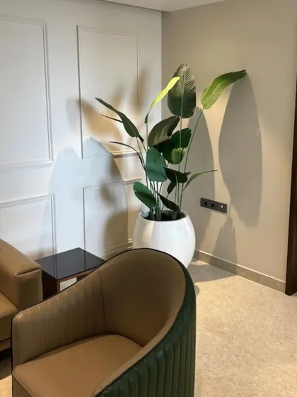 Another angle of the artificial Bird of Paradise plant, showing how it complements the neutral tones of the room. We help you choose the right plant and planter to match your existing home decor.