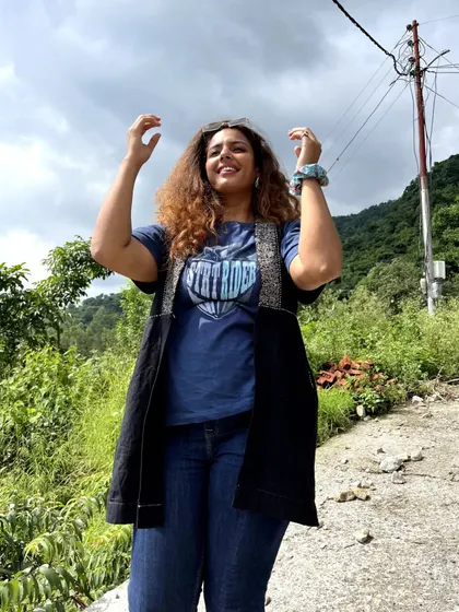 A casual hiking or travel look. I layered a jacket over a graphic tee and jeans. I even borrowed this t-shirt from the men's section, proving that style has no rules.